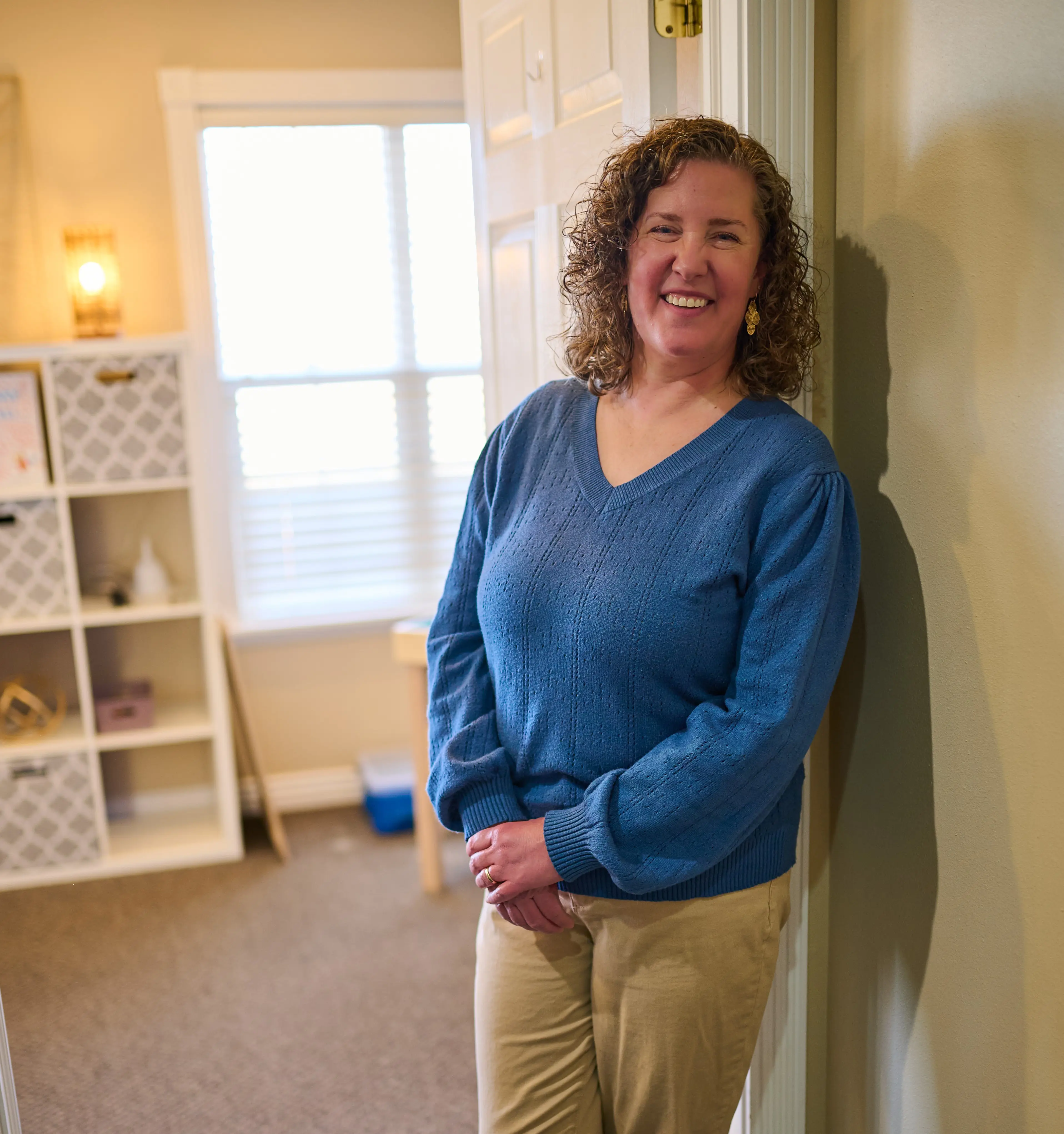 Stephanie standing by door to her office